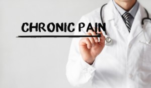 doctor writing out the words "chronic pain"